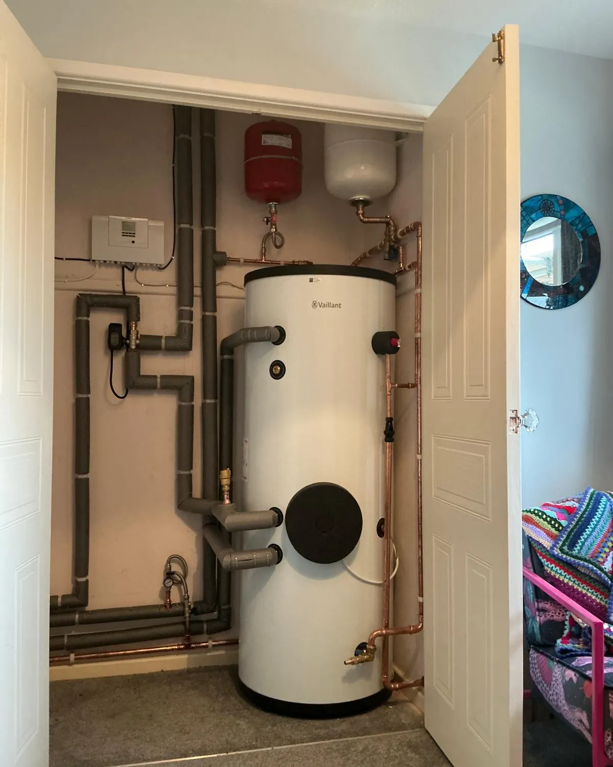 Unvented hot water cylinder fitted in an airing cupboard