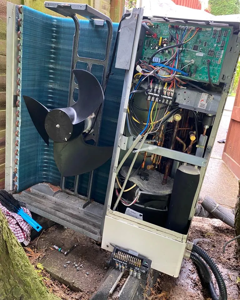 Air source heat pump with its casing open for fault finding
