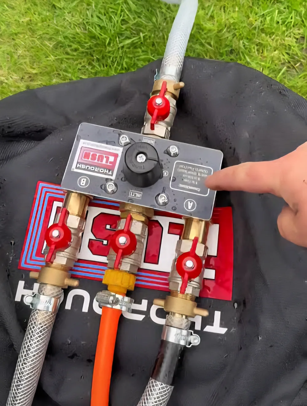 Mains flushing manifold with valves and hoses set up for a central heating mains flush